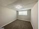 Cozy basement bedroom featuring neutral walls, carpeted floors, and natural light from a window at 3798 Bakers Ferry Sw Rd, Atlanta, GA 30331