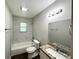 Bathroom features a shower and tub combo, modern fixtures, and granite countertop vanity at 3798 Bakers Ferry Sw Rd, Atlanta, GA 30331