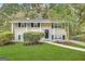Charming two-story home features a white brick exterior, dark shutters, and a well-manicured lawn at 3798 Bakers Ferry Sw Rd, Atlanta, GA 30331