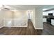 Spacious living room featuring hardwood floors, white staircase and an open floorplan with modern kitchen at 3798 Bakers Ferry Sw Rd, Atlanta, GA 30331