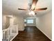 Spacious living area with hardwood floors and ceiling fan, leading to an open kitchen at 3798 Bakers Ferry Sw Rd, Atlanta, GA 30331