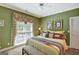 Cozy bedroom with a large window, decorative pillows, and a comfortable bench at 608 Wingspread, Peachtree City, GA 30269