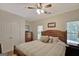Comfortable bedroom with a wooden bed frame, neutral walls, and natural light from the windows at 608 Wingspread, Peachtree City, GA 30269