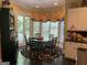 Bright breakfast area featuring a glass-top table, ornate hutch, and ample natural light and backyard access at 608 Wingspread, Peachtree City, GA 30269
