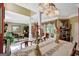 An elegant dining room with a crystal chandelier and open access to a formal living area for refined entertaining at 608 Wingspread, Peachtree City, GA 30269