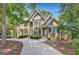 Charming two-story home featuring a circular driveway and meticulous landscaping, nestled among mature trees for added privacy at 608 Wingspread, Peachtree City, GA 30269