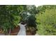 An aerial view showcasing a landscaped home nestled among mature trees offering an intimate setting and privacy at 608 Wingspread, Peachtree City, GA 30269
