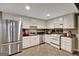 Modern kitchen with stainless steel appliances, white cabinets, and a functional layout at 608 Wingspread, Peachtree City, GA 30269