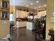 Open kitchen view with white cabinets, black countertops, an island, and hanging pot rack at 608 Wingspread, Peachtree City, GA 30269
