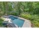 A pool surrounded by a lush green trees and vegetation at 608 Wingspread, Peachtree City, GA 30269