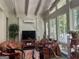 Bright sunroom with large windows, vaulted ceiling, and cozy wicker furniture, perfect for relaxation at 608 Wingspread, Peachtree City, GA 30269