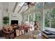 Bright sunroom featuring vaulted ceilings and lots of windows offering views of the yard, creating a cozy and relaxing atmosphere at 608 Wingspread, Peachtree City, GA 30269