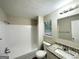 Bright bathroom with granite vanity top, window, and tiled tub-shower combination at 3865 Lehigh Blvd, Decatur, GA 30034