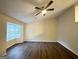 Bedroom featuring a ceiling fan, wood floors, and a large window at 3865 Lehigh Blvd, Decatur, GA 30034