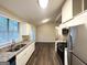 Updated kitchen features granite counters, stainless appliances, vaulted ceiling, and access to a dining area at 3865 Lehigh Blvd, Decatur, GA 30034