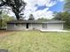 A well-maintained backyard with a gray brick exterior and a lush green lawn at 4140 Pierce Rd, South Fulton, GA 30349
