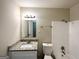Well-lit bathroom featuring a granite countertop vanity and a shower-tub combination at 4140 Pierce Rd, South Fulton, GA 30349