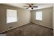 Bedroom featuring neutral walls and carpet with natural light from two windows and ceiling fan at 4140 Pierce Rd, South Fulton, GA 30349