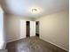 Bedroom with neutral carpet and walls, featuring a closet with sliding doors at 4140 Pierce Rd, South Fulton, GA 30349