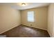 Cozy bedroom with neutral walls and carpet, with a window providing natural light at 4140 Pierce Rd, South Fulton, GA 30349