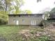 Exterior view of the home's backyard featuring a grassy yard and patio at 4505 Wonder Valley Trl, Decatur, GA 30034