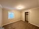 This bedroom features neutral walls, carpeting, a window, and a closet for ample storage at 4505 Wonder Valley Trl, Decatur, GA 30034