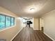 Bright dining area with new floors, neutral walls, and a view into the kitchen and backyard at 4505 Wonder Valley Trl, Decatur, GA 30034