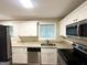 Updated kitchen with granite countertops, stainless appliances, and white cabinetry at 4505 Wonder Valley Trl, Decatur, GA 30034