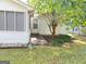 Backyard featuring a well-maintained lawn, mature trees, and a cozy outdoor living space at 3041 Regal Dr, Mcdonough, GA 30253