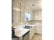 Bright kitchen with white cabinets, countertops, and stainless steel sink at 3041 Regal Dr, Mcdonough, GA 30253