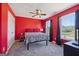 Red bedroom has two windows with black curtains and a patterned comforter on the bed at 125 Anna Dr, Covington, GA 30014