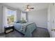 Cozy bedroom featuring a ceiling fan, carpet, and two windows that let in natural light at 125 Anna Dr, Covington, GA 30014