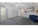 Bright bonus room with fun wall decor, gray carpet, and a white door at 125 Anna Dr, Covington, GA 30014
