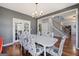Well-lit dining room with hardwood floors, a chandelier, and a view of the staircase, ideal for Gathering gatherings at 125 Anna Dr, Covington, GA 30014