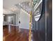 Inviting entryway with hardwood floors, a staircase, and a view of the dining area, showcasing a welcoming ambiance at 125 Anna Dr, Covington, GA 30014