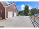 Brick home featuring a three-car garage and spacious driveway at 125 Anna Dr, Covington, GA 30014