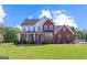 Beautiful two-story brick home with a large front lawn and covered porch, perfect for suburban living at 125 Anna Dr, Covington, GA 30014