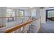 Second floor hallway with staircase and plenty of natural light with views of the neighborhood at 125 Anna Dr, Covington, GA 30014