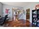 Beautiful hallway with hardwood floors that leads to the staircase and other rooms at 125 Anna Dr, Covington, GA 30014