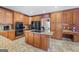 Modern kitchen featuring granite countertops, an island cooktop, and stainless steel appliances at 125 Anna Dr, Covington, GA 30014