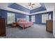 A Primary bedroom with tray ceilings, ample natural light, and a serene atmosphere at 125 Anna Dr, Covington, GA 30014