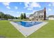 Backyard view of a sparkling in-ground pool with lounge chairs, patio, and a grassy area, ideal for outdoor entertaining at 125 Anna Dr, Covington, GA 30014
