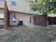 Backyard view features a small concrete patio with wooden privacy fence and an air conditioning unit at 1853 Broad River Rd, Atlanta, GA 30349