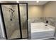 A bathroom features a shower and a tub at 1853 Broad River Rd, Atlanta, GA 30349