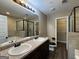 A bathroom features dual sinks, a large mirror, and a walk-in shower at 1853 Broad River Rd, Atlanta, GA 30349