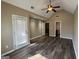 A bedroom with a vaulted ceiling, ceiling fan, dark wood floors, and a door to a balcony at 1853 Broad River Rd, Atlanta, GA 30349