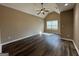 A bedroom with a vaulted ceiling, ceiling fan, and dark wood floors at 1853 Broad River Rd, Atlanta, GA 30349
