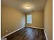 The bedroom has a window and dark vinyl flooring at 1853 Broad River Rd, Atlanta, GA 30349