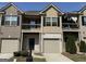 Charming townhome with a private balcony, attached garages, and well-maintained landscaping at 1853 Broad River Rd, Atlanta, GA 30349