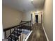 A long hallway with dark wood floors and railings at 1853 Broad River Rd, Atlanta, GA 30349